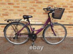 Apollo Elyse Hybrid bike with a front basket, rear rack carrier, mudguards