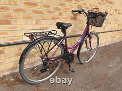 Apollo Elyse Hybrid bike with a front basket, rear rack carrier, mudguards