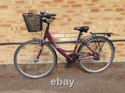 Apollo Elyse Hybrid bike with a front basket, rear rack carrier, mudguards