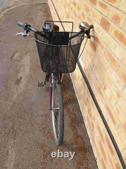 Apollo Elyse Hybrid bike with a front basket, rear rack carrier, mudguards